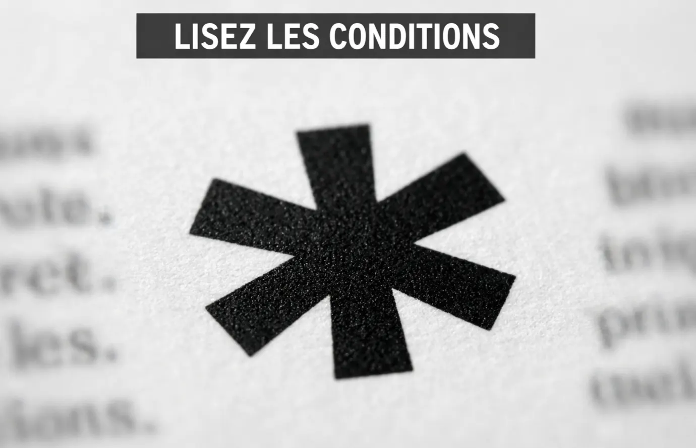 Petit panneau publicitaire avec un astérisque visible en gros plan, texte flou en arrière-plan